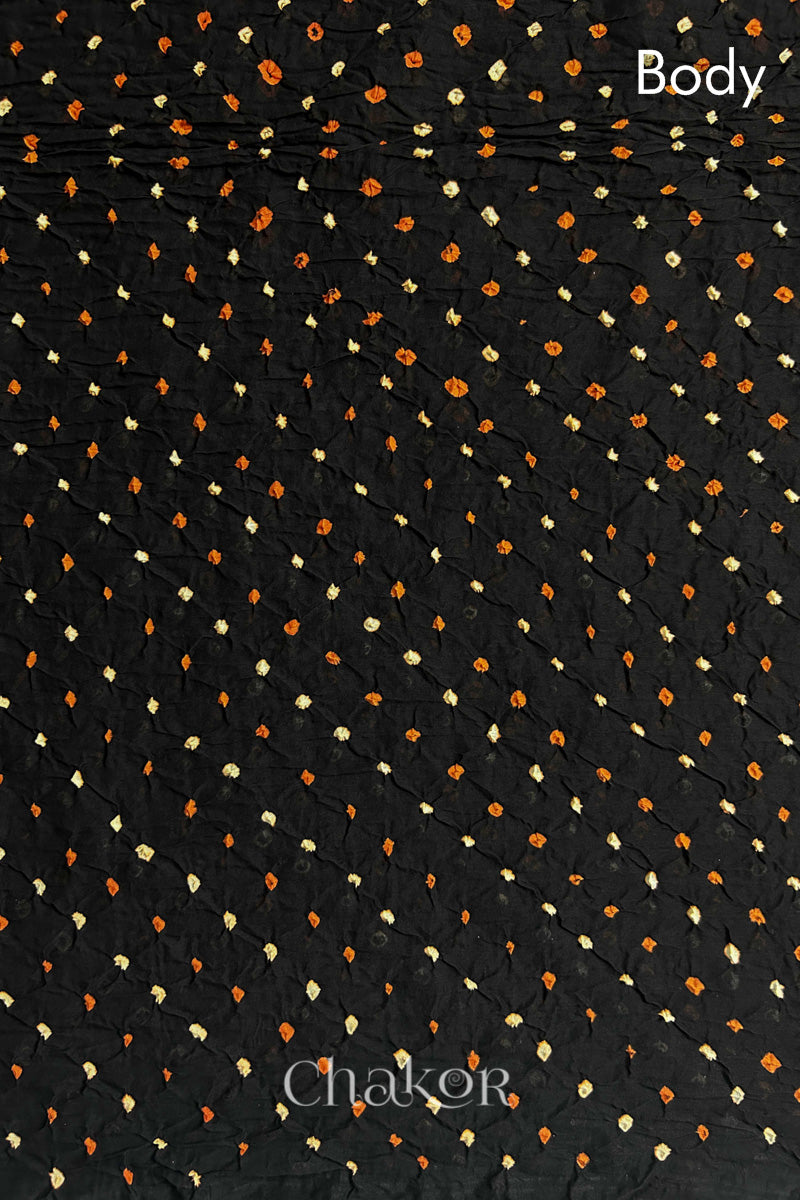 Body detail of Black and Magenta Bandhani Mul Cotton Saree featuring multicoloured bandhej patterns.