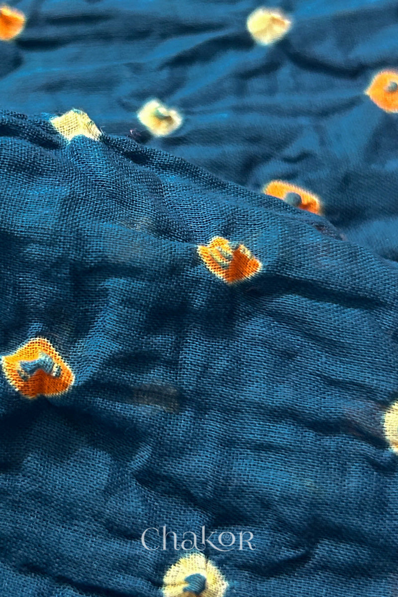 Close up of Indigo body and Red pallu Bandhani Mul Cotton Saree featuring multicoloured bandhani patterns.