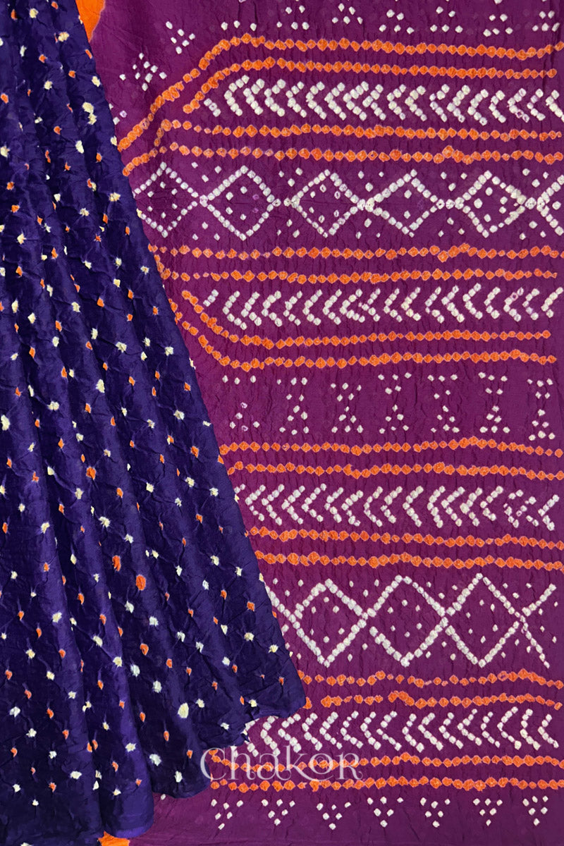 Purple pleats and Magenta Pallu of Bandhani Mul Cotton Saree featuring multicoloured bandhani patterns.