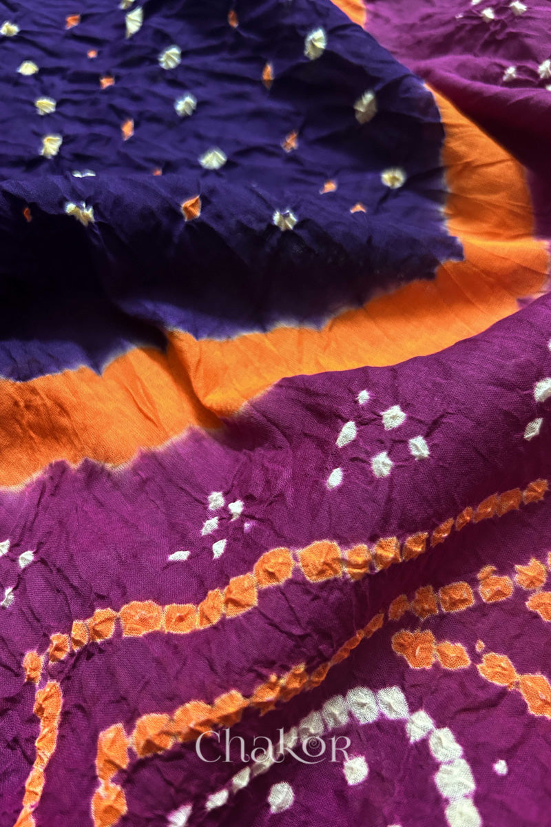 Close up of Purple and Magenta Bandhani Mul Cotton Saree featuring multicoloured bandhani patterns.