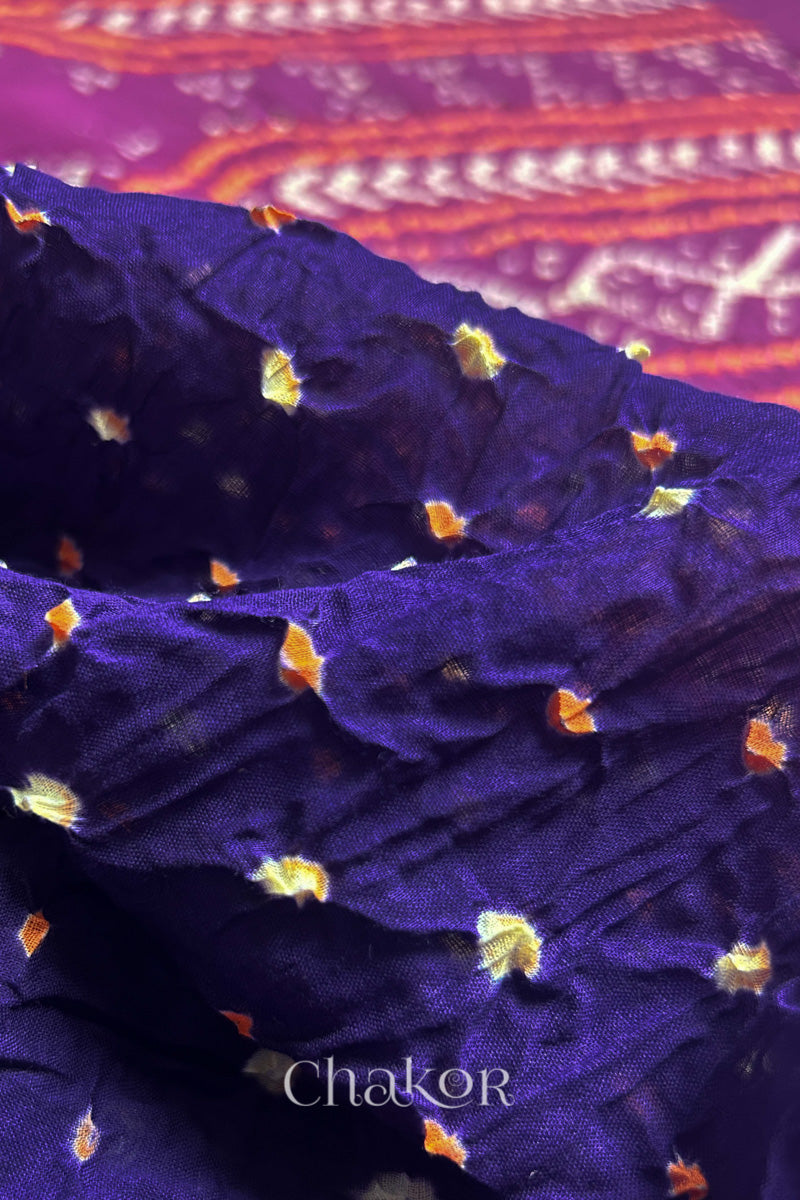 Close up of Purple and Magenta Bandhani Mul Cotton Saree featuring multicoloured bandhani patterns.