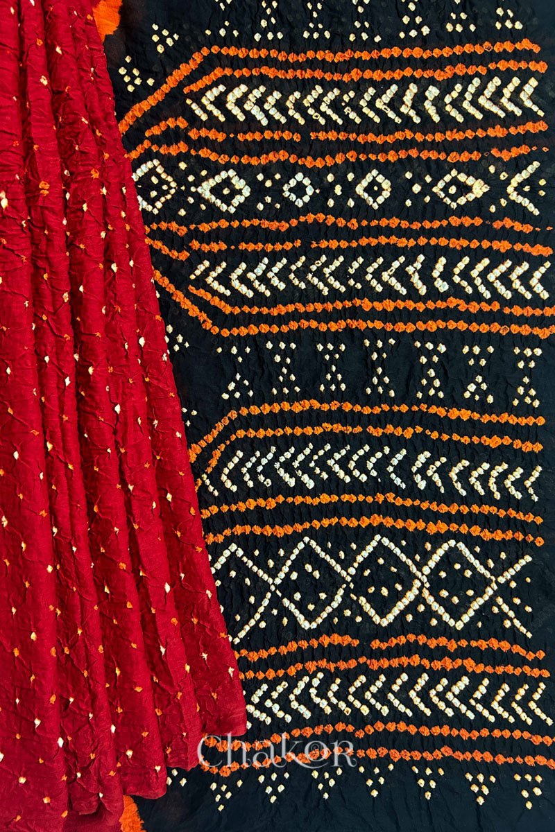 Red pleats and black pallu view of Red Black Bandhani Mul Cotton Saree featuring multicouloured bandhani patterns.