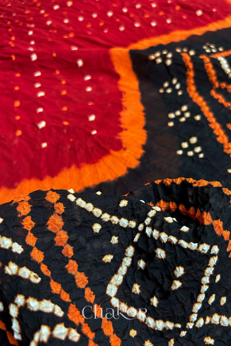 Close up of Red Black Bandhani Mul Cotton Saree featuring multicouloured bandhani patterns.