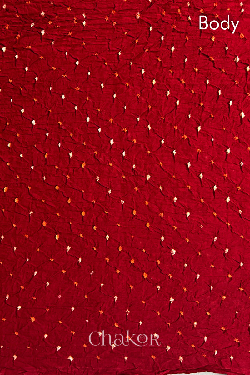 Body detail of Red body Black pallu of  Bandhani Mul Cotton Saree featuring multicouloured bandhani patterns.