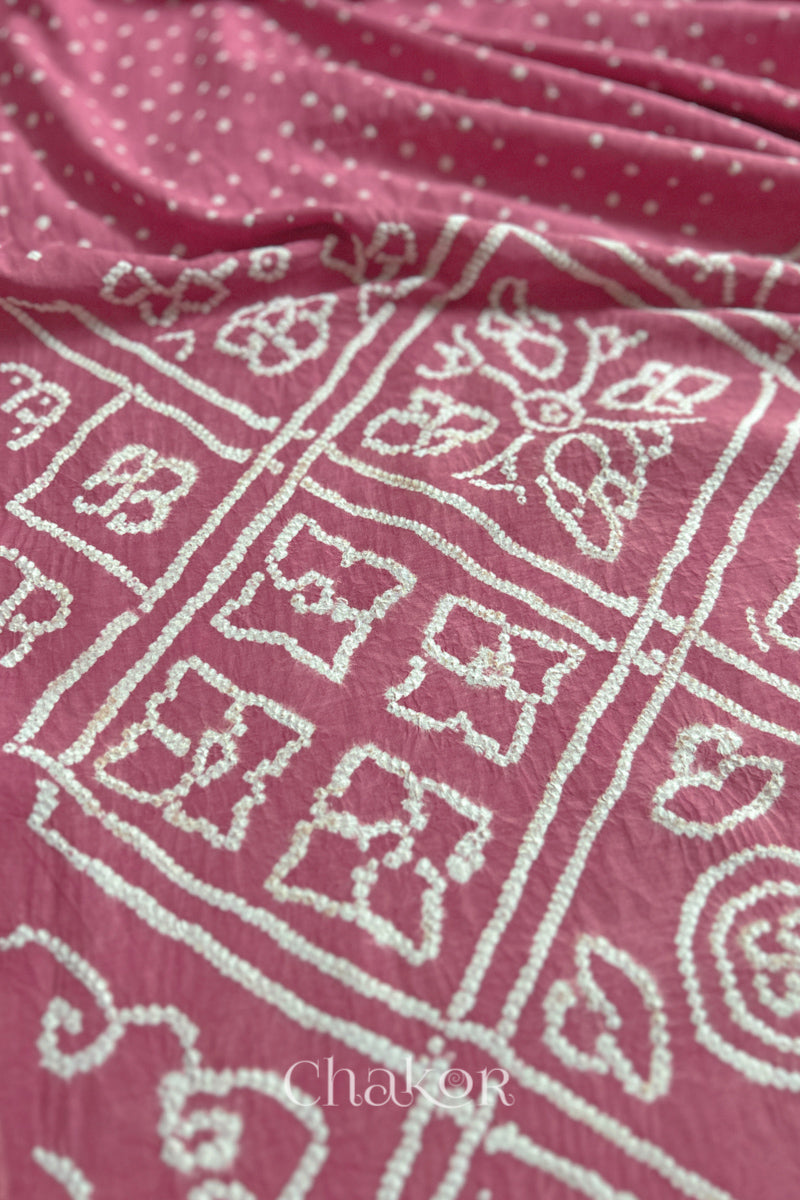 Close-up of Old rose sarees featuring rai bandhani  showcasing beautiful craftsmanship.
