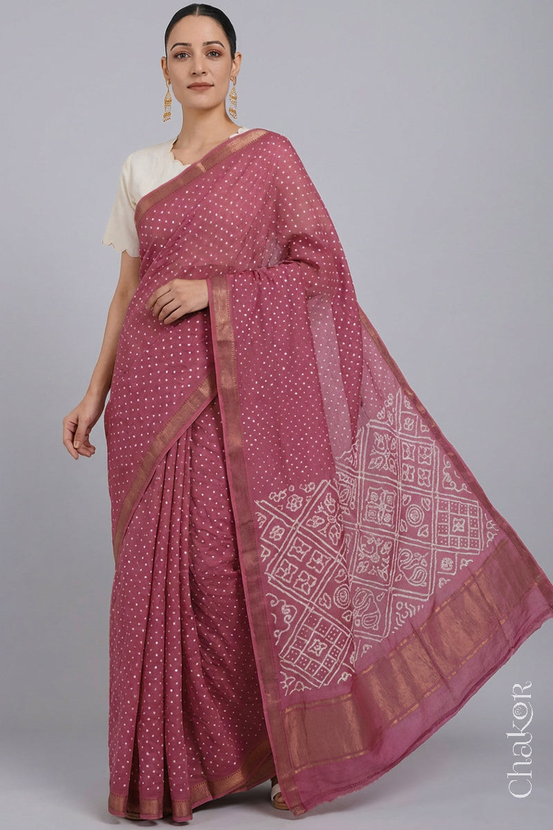 Woman wearing Rose pink Bandhani Mangalagiri Handloom Cotton Saree, with handcrafted rai bandhej patterns using traditional tie-dye techniques.