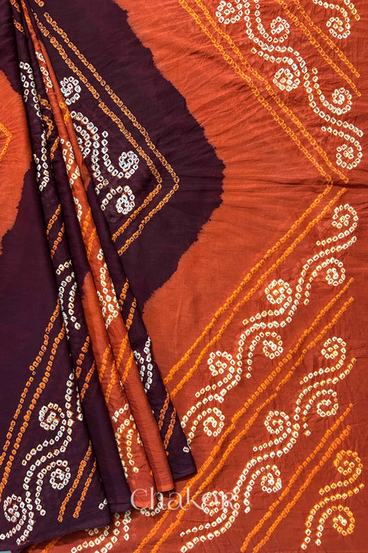 Pleat and pallu view of Maroon Rust Bandhani Mul Cotton Saree featuring multicoloured bandhani patterns.