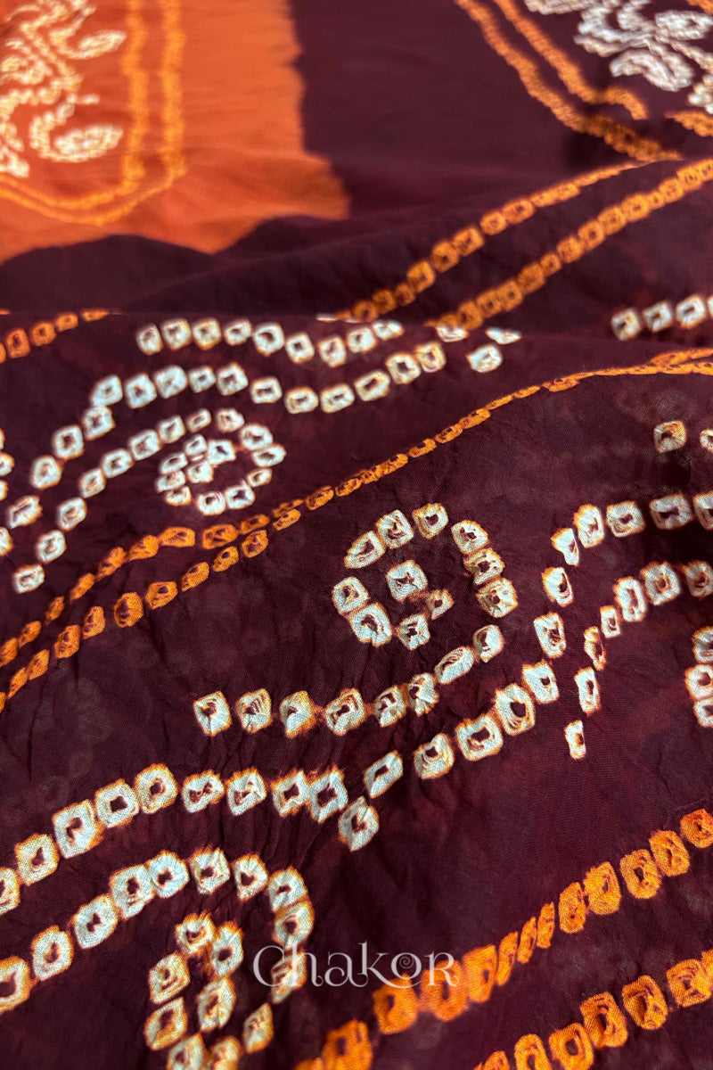 Close up of Maroon Rust Bandhani Mul Cotton Saree featuring multicoloured bandhani patterns.