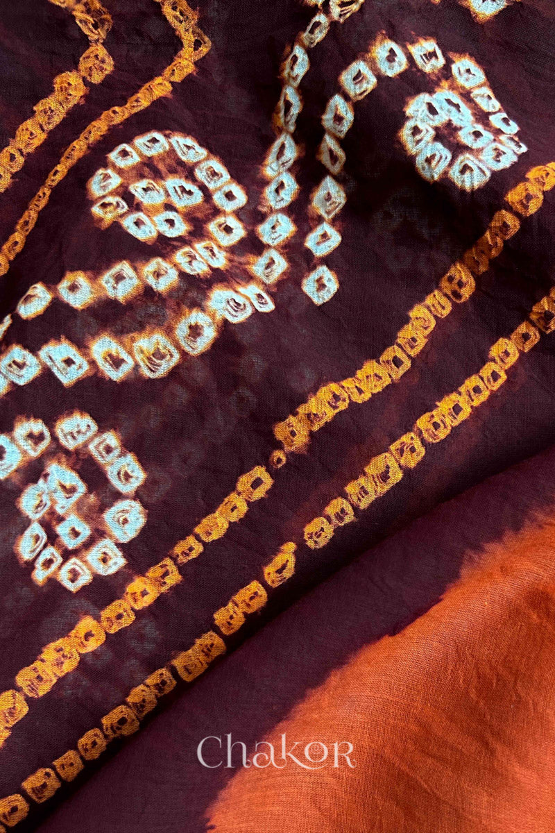 Close up of Maroon Rust Bandhani Mul Cotton Saree featuring multicoloured bandhani patterns.
