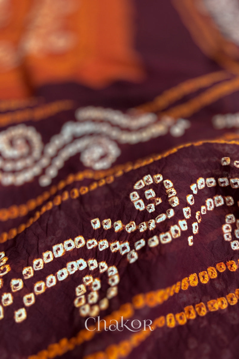 Close up of Maroon Rust Bandhani Mul Cotton Saree featuring multicoloured bandhani patterns.