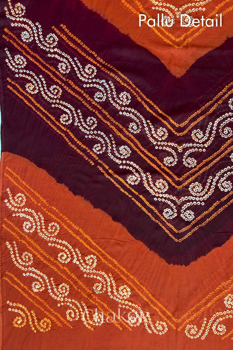 Pallu detail of Maroon Rust Bandhani Mul Cotton Saree featuring multicoloured bandhani patterns.