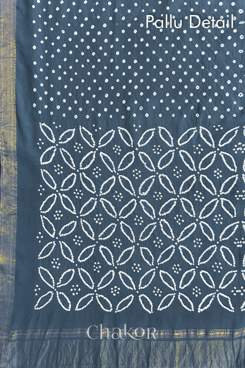 Pallu detail of grey bandhani saree with woven golden zari border and pallu.
