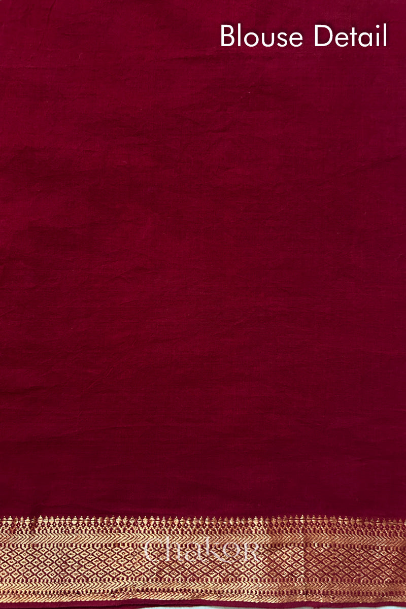 Blouse detail of Red bandhani saree with woven golden zari border.
