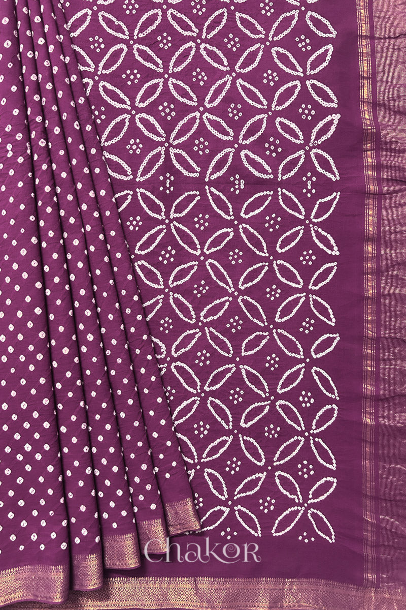 Purple saree, neatly arranged in pleats with Rai Bandhej traditional design and 'Chakor' brand watermark.
