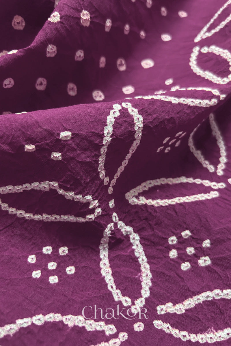 Close-up of Purple sarees featuring rai bandhani showcasing beautiful craftsmanship.
