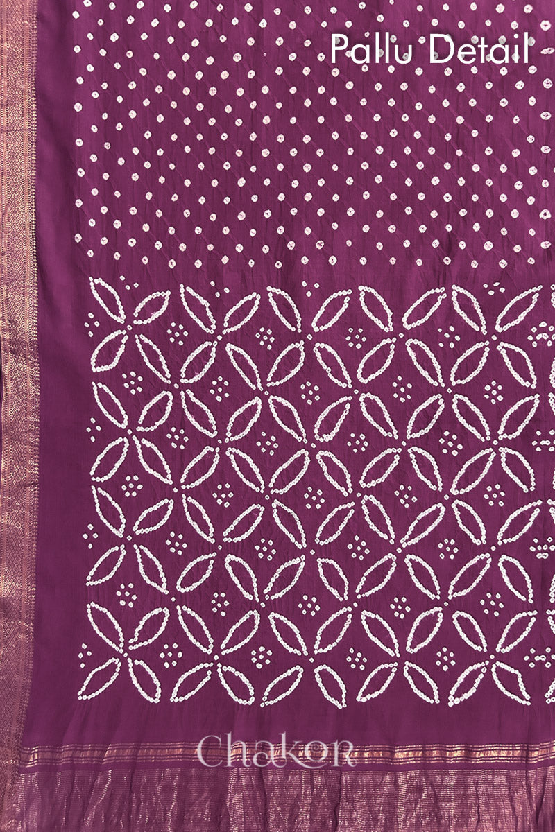 Pallu detail of Purple bandhani saree with woven golden zari border and pallu.
