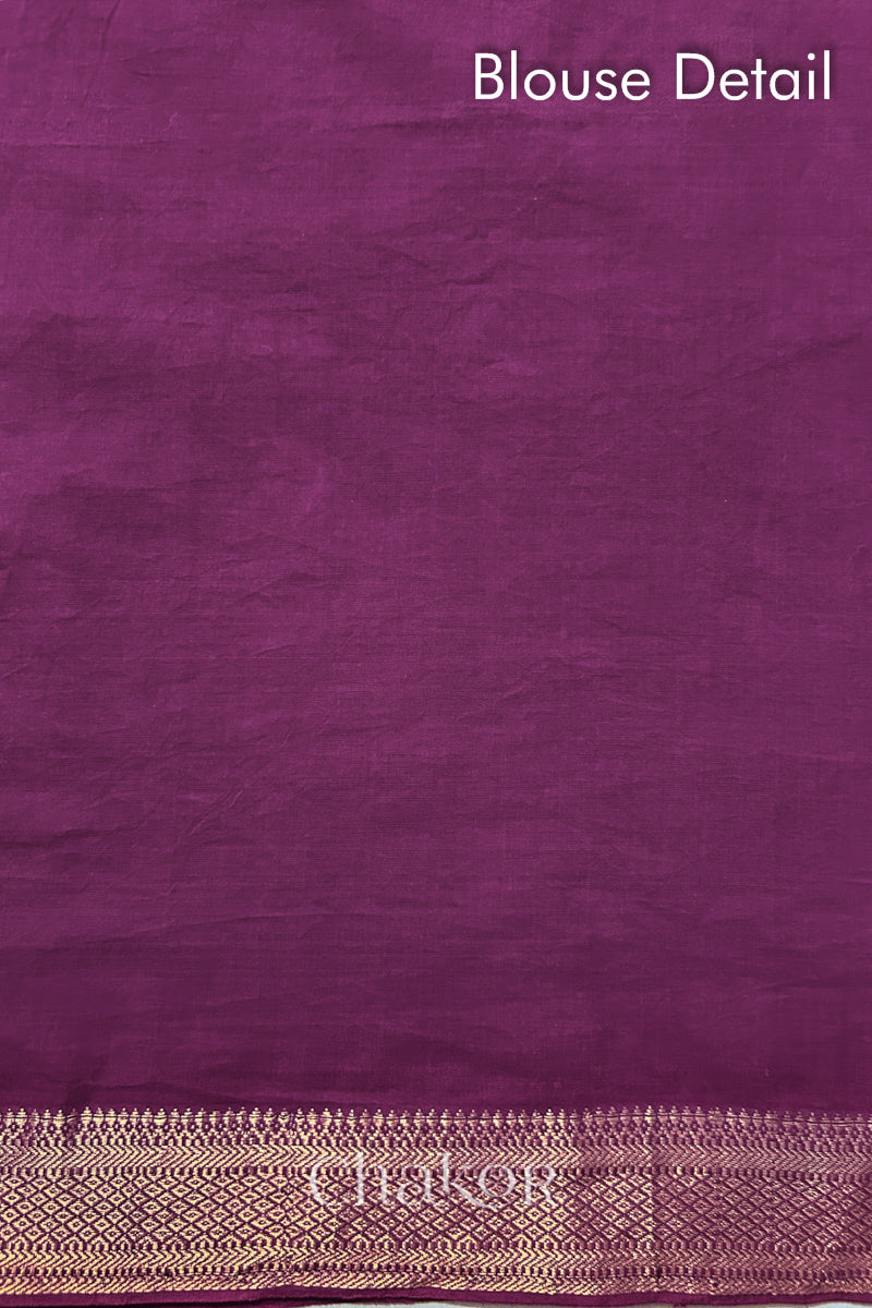 Blouse detail of Purple bandhani saree with woven golden zari border.
