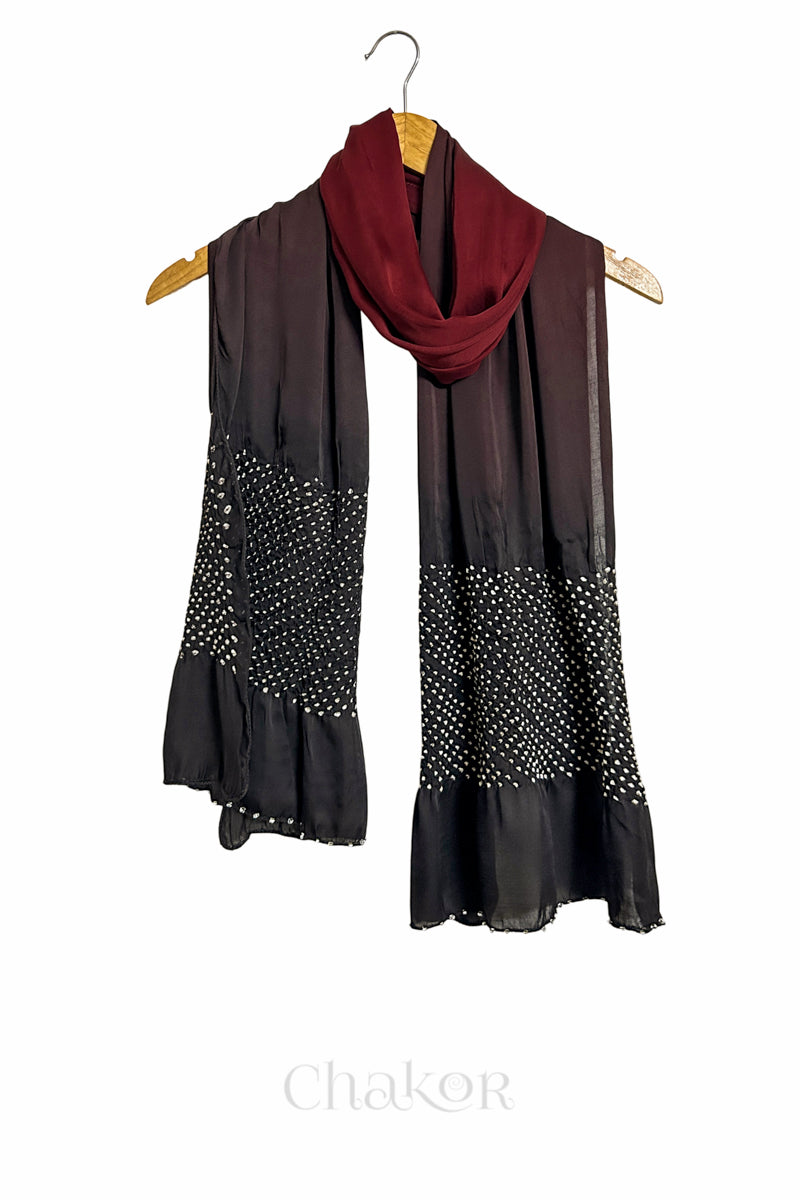 Black and maroon ombre bandhani  scarf with beads detailing on a hanger, brand 'Chakor' visible.