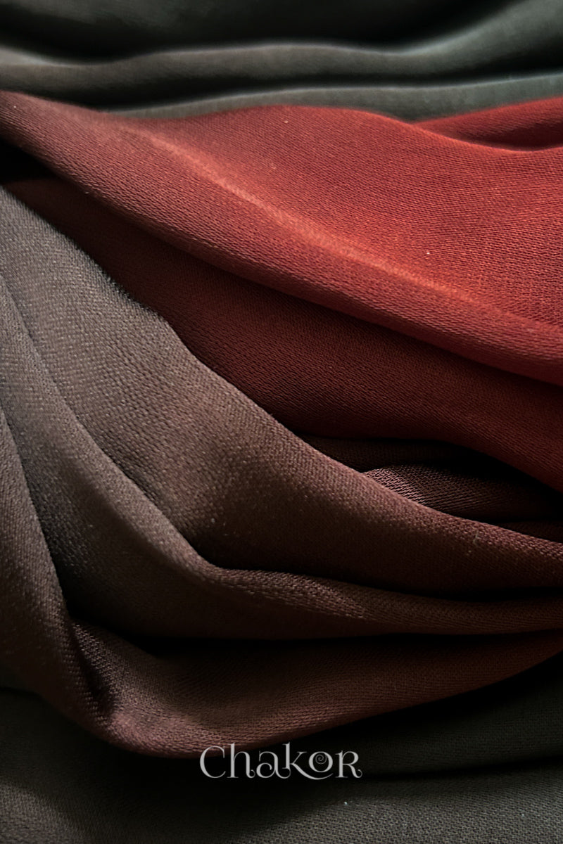 Close-up of bandhani stole featuring ombre dyeing and lustrous texture of modal fabric with 'Chakor' branding.