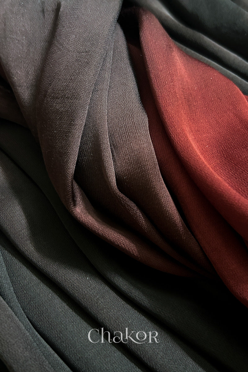 Close-up of bandhani stole featuring ombre dyeing in maroon & black on lustrous modal fabric with 'Chakor' branding.
