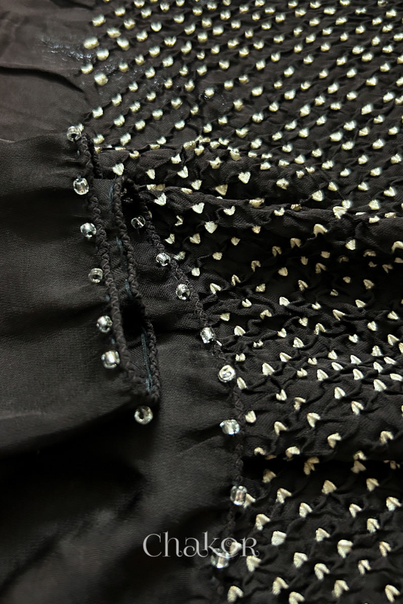 Close-up of bandhani stole featuring ombre dyeing & intricate tie dye and beads edging with 'Chakor' branding.