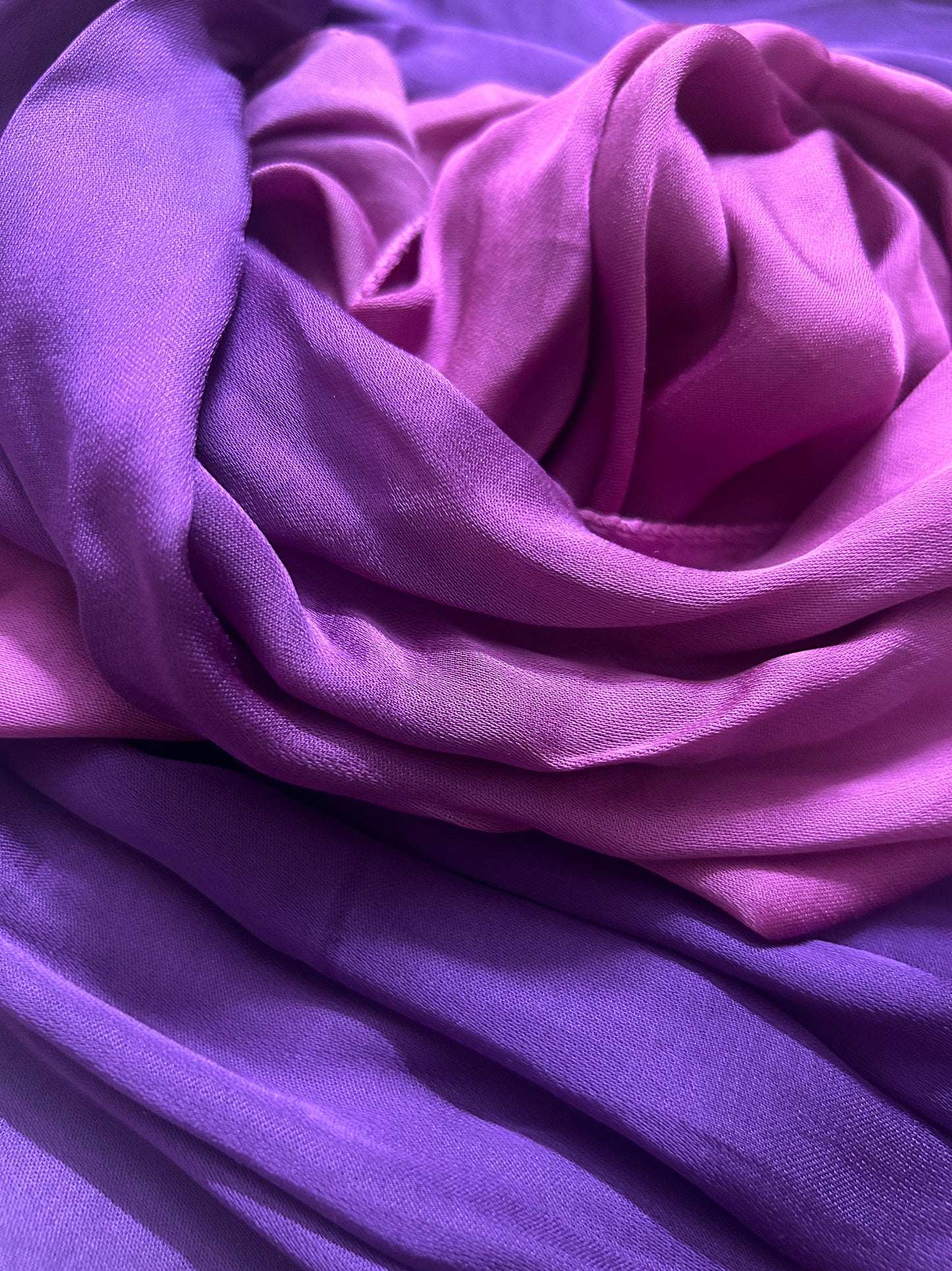Close-up of bandhani stole featuring ombre dyeing in magenta & purple on lustrous modal fabric with 'Chakor' branding.
