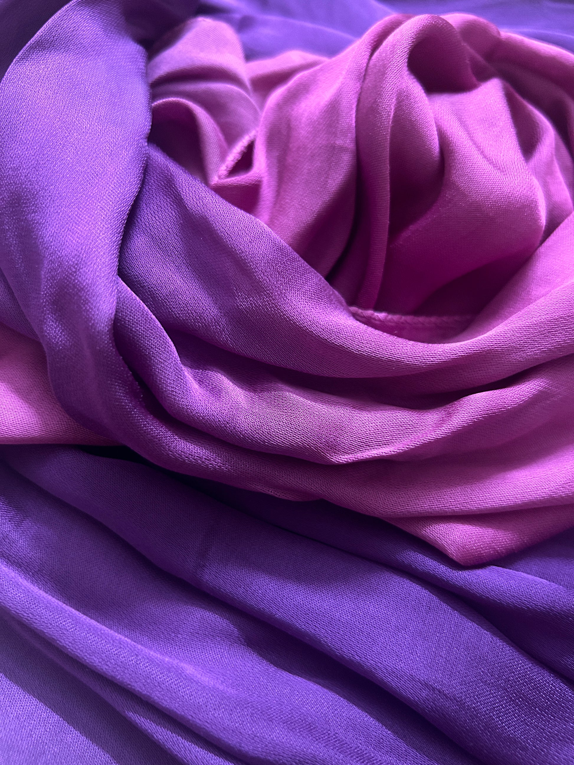Close-up of bandhani stole featuring ombre dyeing in magenta & purple on lustrous modal fabric with 'Chakor' branding.
