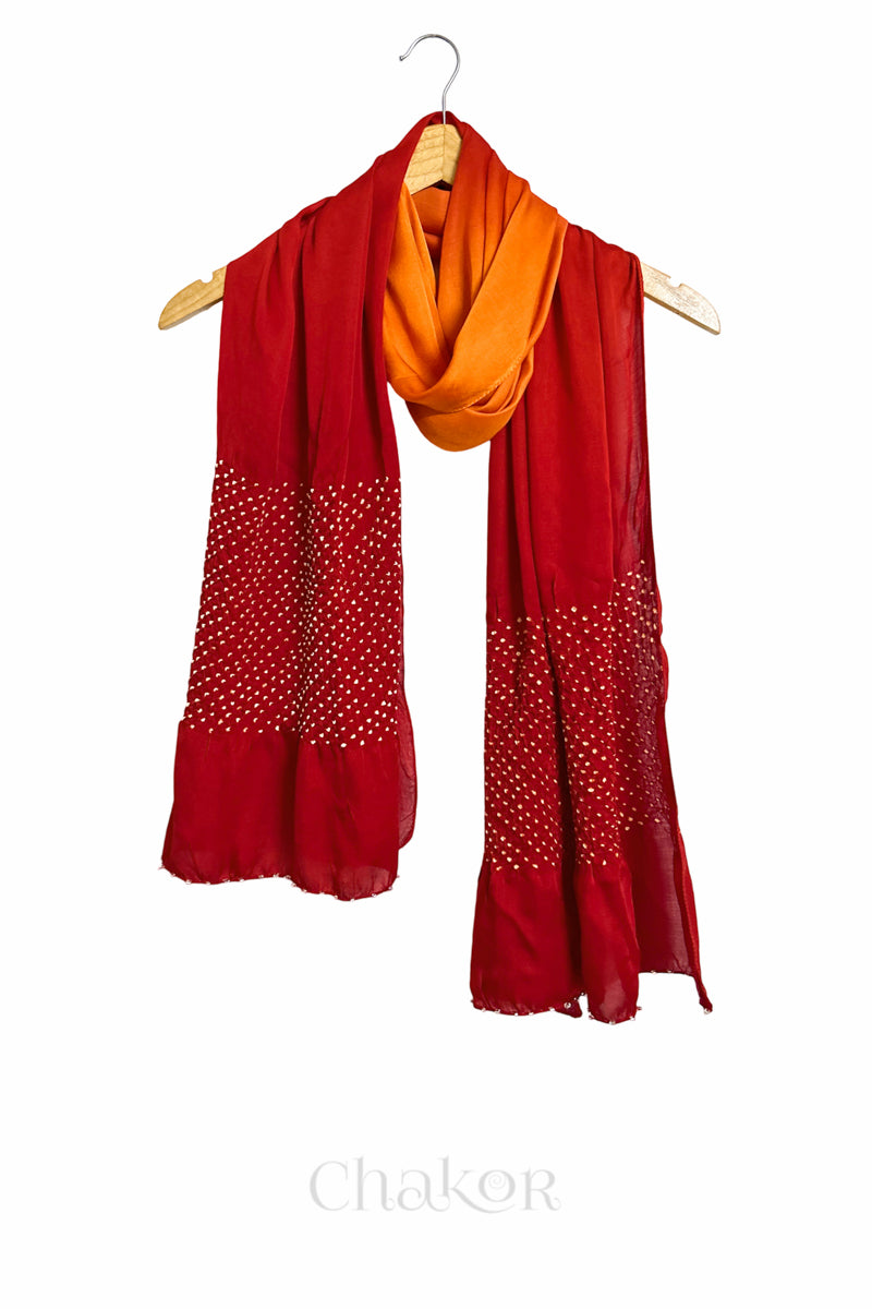 orange & red ombre bandhani  scarf with beads detailing on a hanger, brand 'Chakor' visible.
