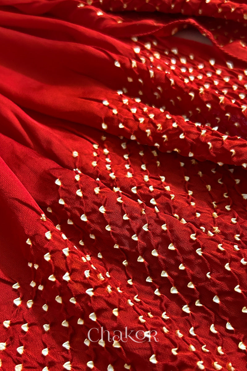 Close-up of bandhani stole featuring ombre dyeing & intricate tie dye and beads edging with 'Chakor' branding.
