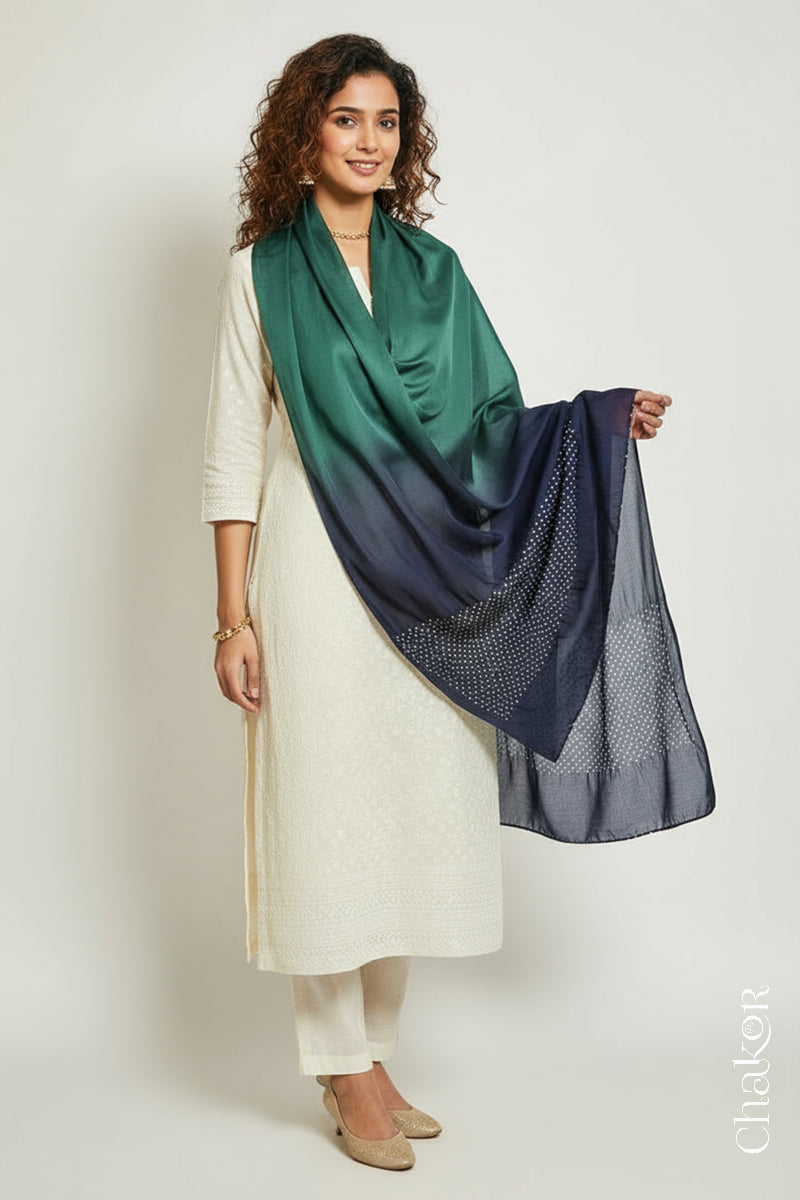 Woman wearing a teal & mauve shaded bandhani stole on white kurta set.
