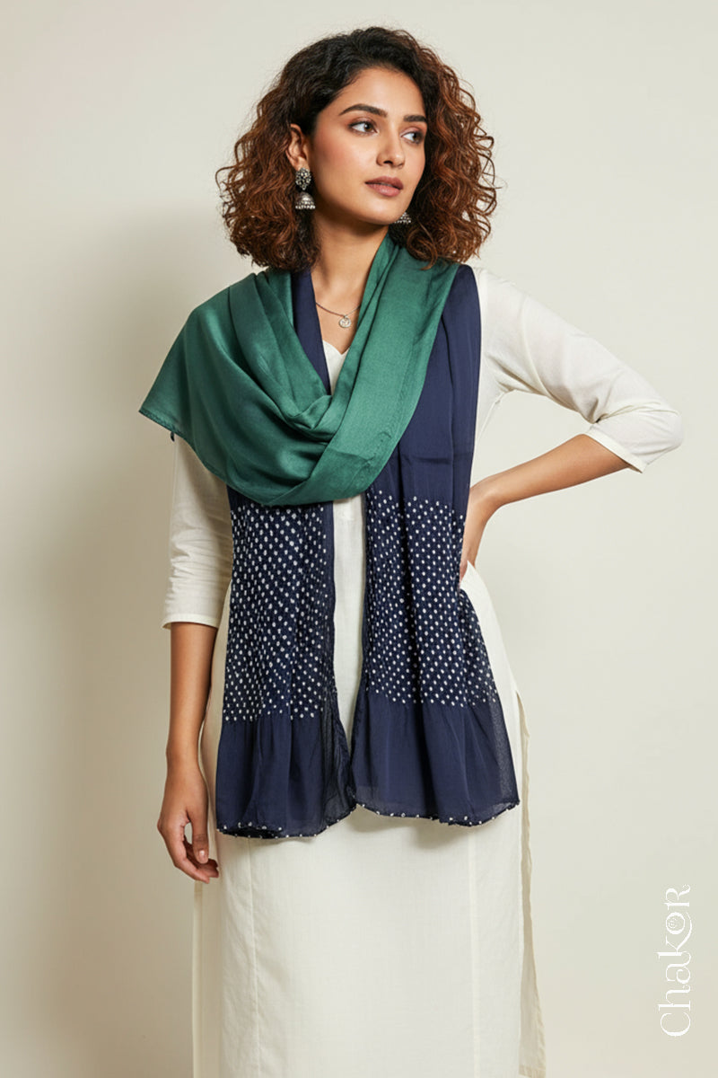 Woman wearing a teal & mauve shaded bandhani stole on white kurta set.
