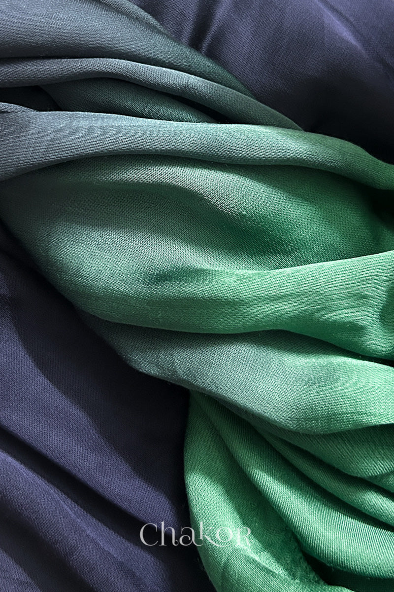 Close-up of bandhani stole featuring ombre dyeing in teal & mauve on lustrous modal fabric with 'Chakor' branding.
