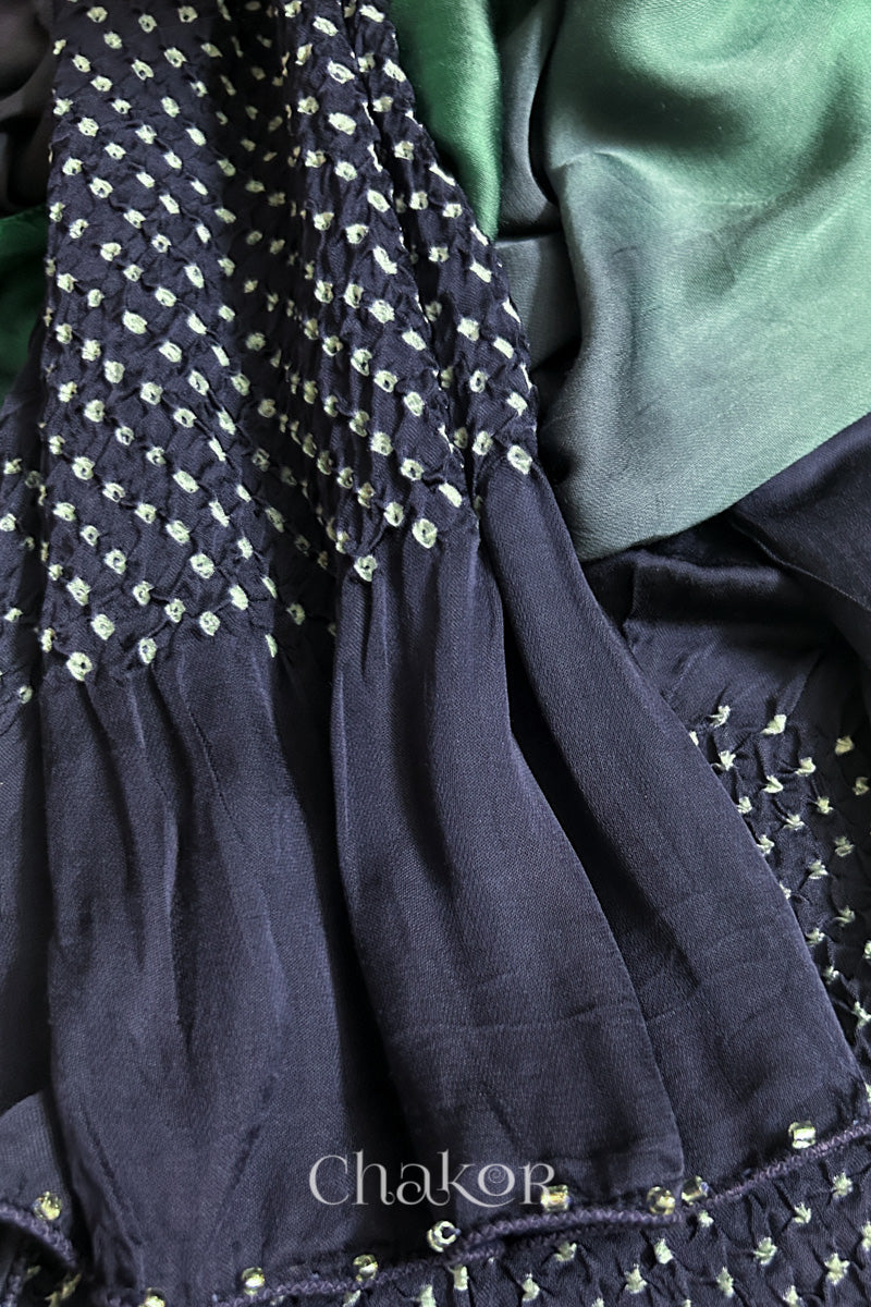 Close-up of bandhani stole featuring ombre dyeing & intricate tie dye and beads edging with 'Chakor' branding.
