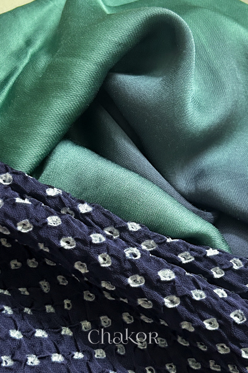 Close-up of bandhani stole featuring ombre dyeing in teal & mauve on lustrous modal fabric with 'Chakor' branding.
