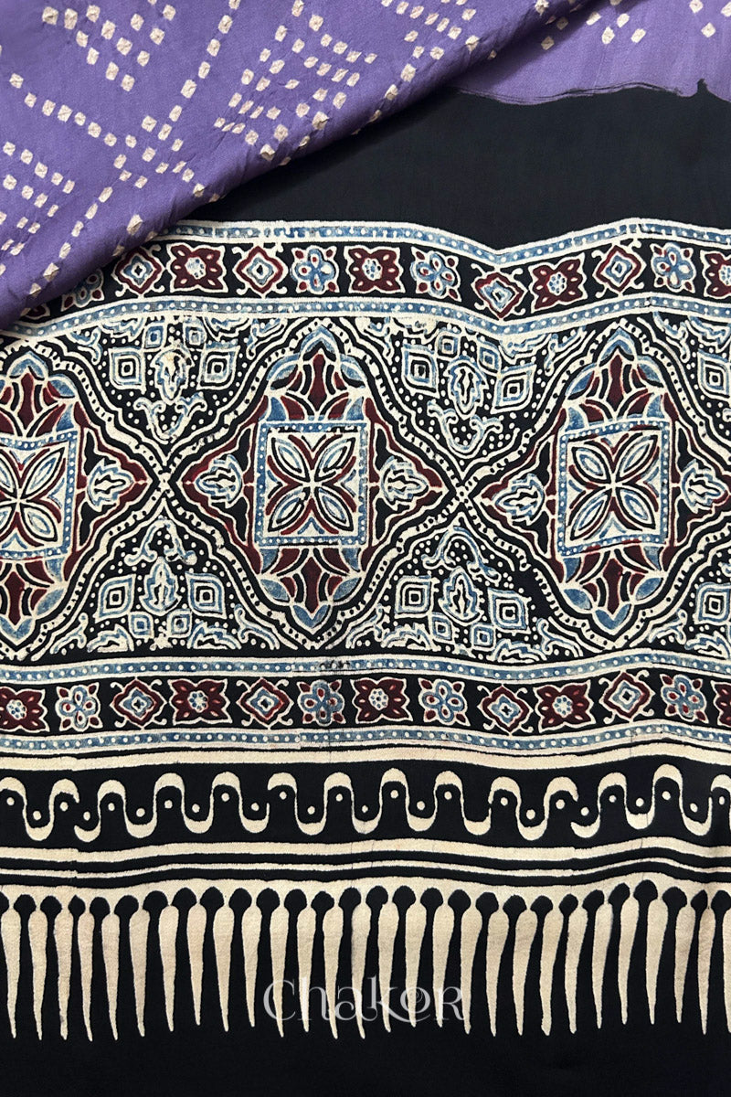 Mauve Hand tied Bandhani patterns on modal stole with contrast black ajrakh pallu detail.
