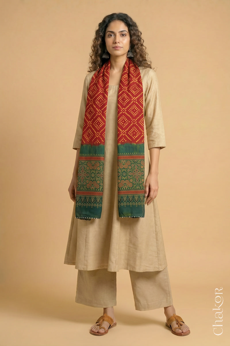 Handcrafted Bandhani Ajrakh modal stole draped on model with  Red Bandhani body and Green Ajrakh pallu.

