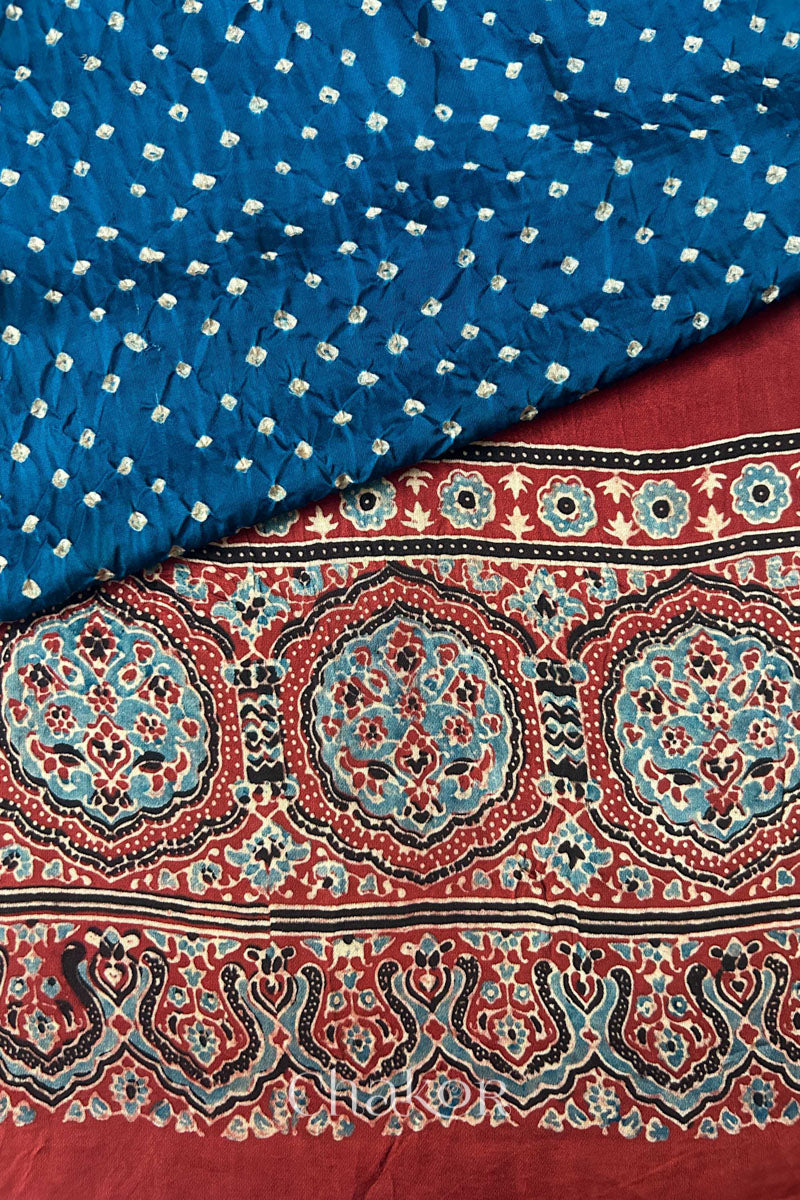 Blue Hand tied Bandhani patterns on modal stole with contrast red ajrakh pallu detail.
