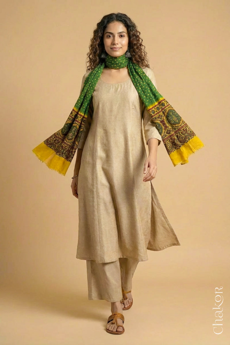 Flowing Green modal Bandhani stole with Mustard Ajrakh pallu showing movement and lightweight drape.
