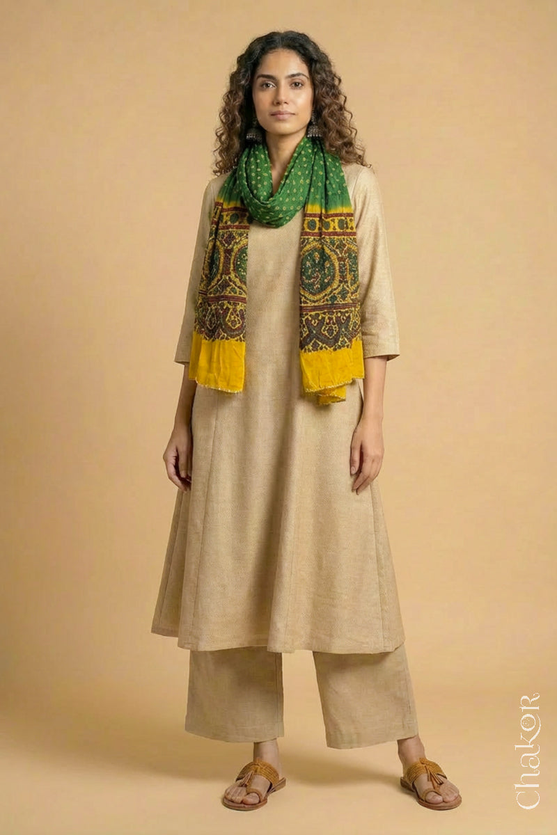 Full length view of handcrafted  Green Bandhani stole with Mustard Ajrakh pallu worn as dupatta wrapped around the neck.
