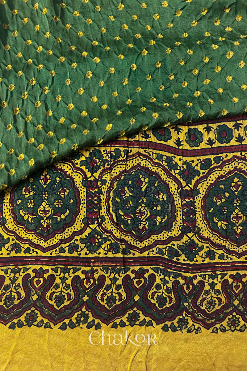 Hand tied  Green Bandhani patterns on modal stole with contrast  Mustard Ajrakh pallu detail.
