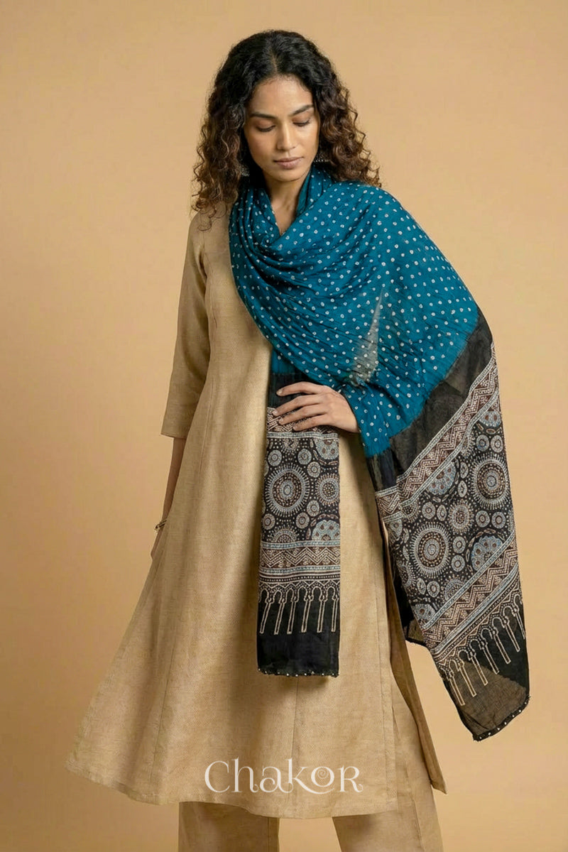 indigo blue bandhani modal stole styled across shoulders with detailed black Ajrakh pallu and traditional hand tied pattern.
