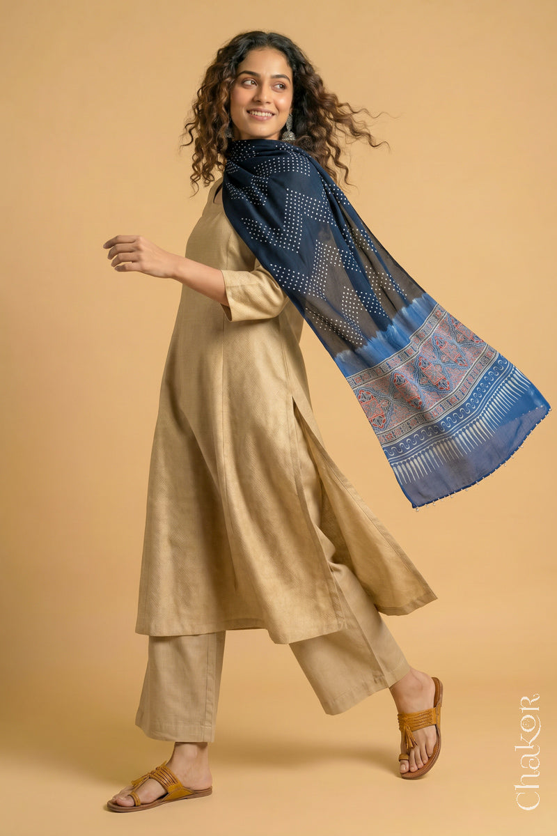 Flowing Black modal Bandhani stole with Indigo Ajrakh pallu showing movement and lightweight drape.
