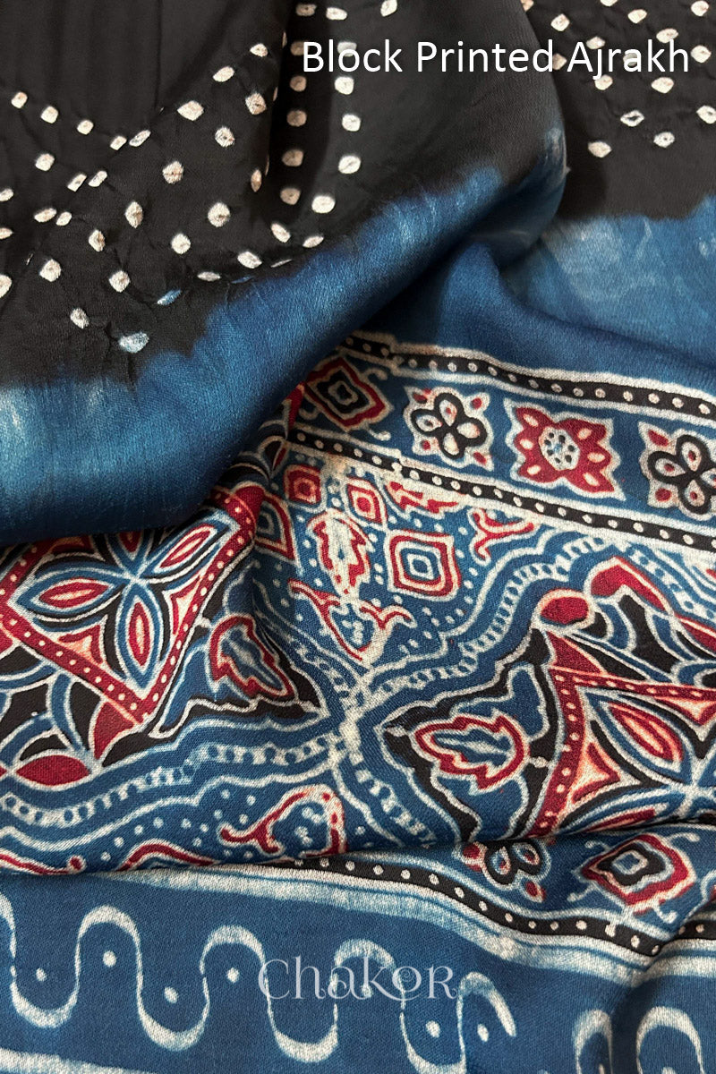 Close up of natural dye Indigo Ajrakh print on handcrafted stole with intricate block printed motifs and delicate bandhani patterns.
