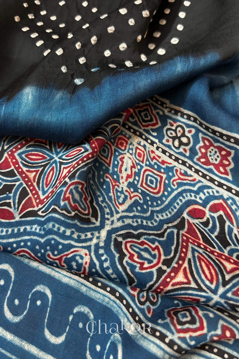 Detailed Ajrakh pattern on modal stole showing traditional hand block printing and intricate bandhani motifs.
