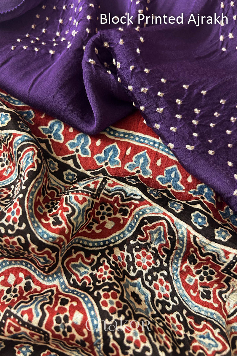 Close up of natural dye Madder Red Ajrakh print on handcrafted stole with intricate block printed motifs and delicate bandhani patterns.

