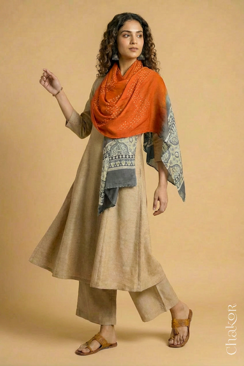 Flowing Orange modal Bandhani stole with Taupe Beige Ajrakh pallu showing movement and lightweight drape.
