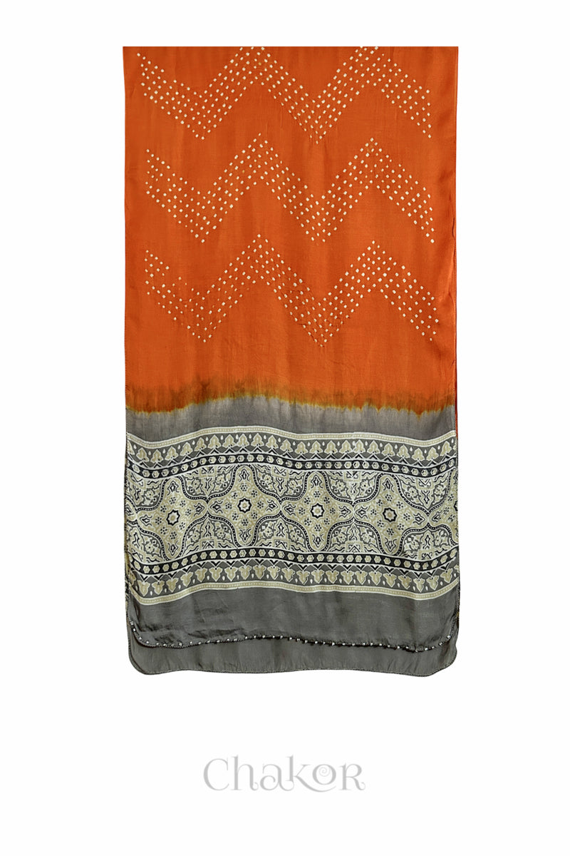 Orange Bandhani modal stole with  Taupe Beige Ajrakh pallu and traditional block print layout and glass bead edging.
