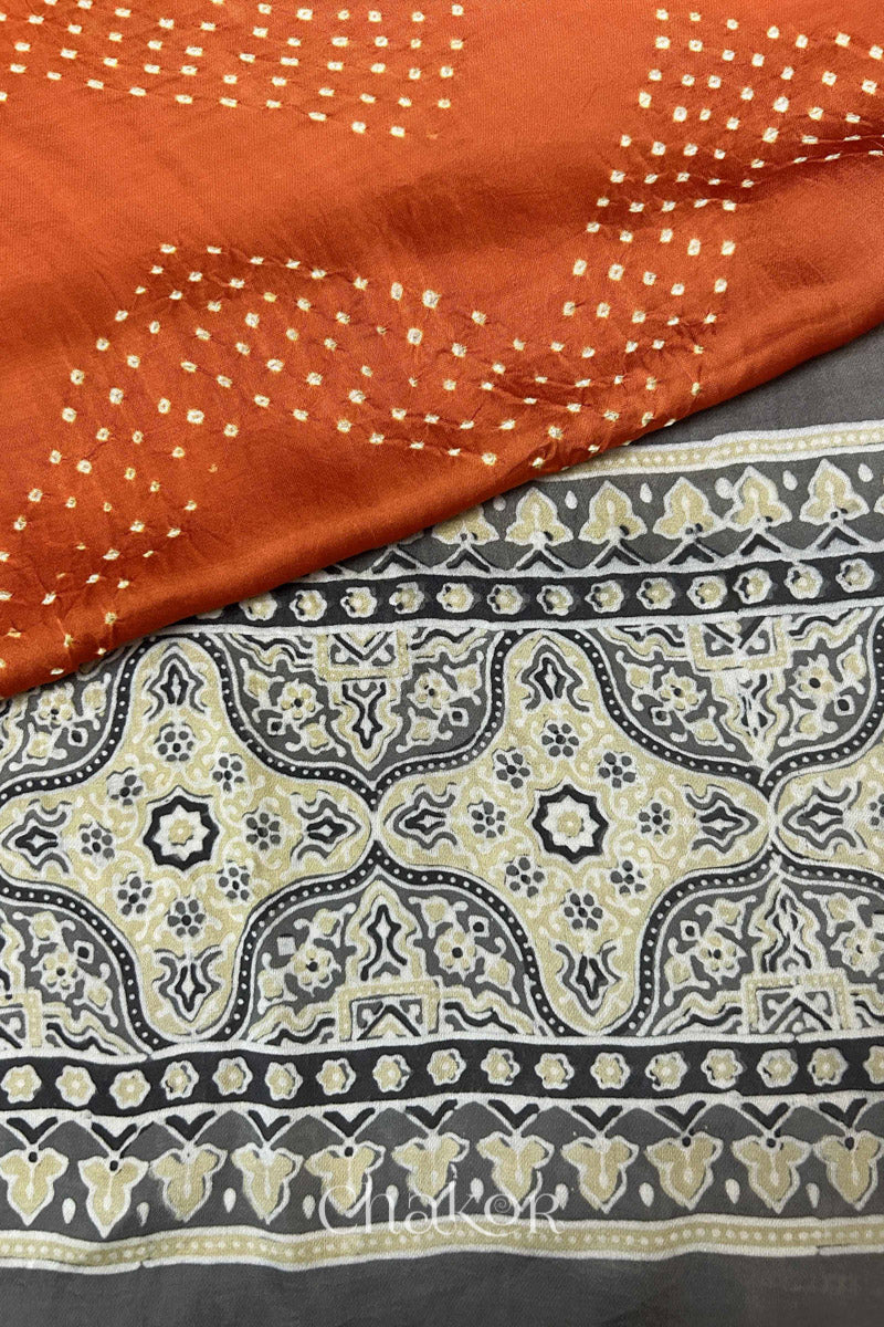 Hand tied  Orange Bandhani patterns on modal stole with contrast  Taupe Beige Ajrakh pallu detail.
