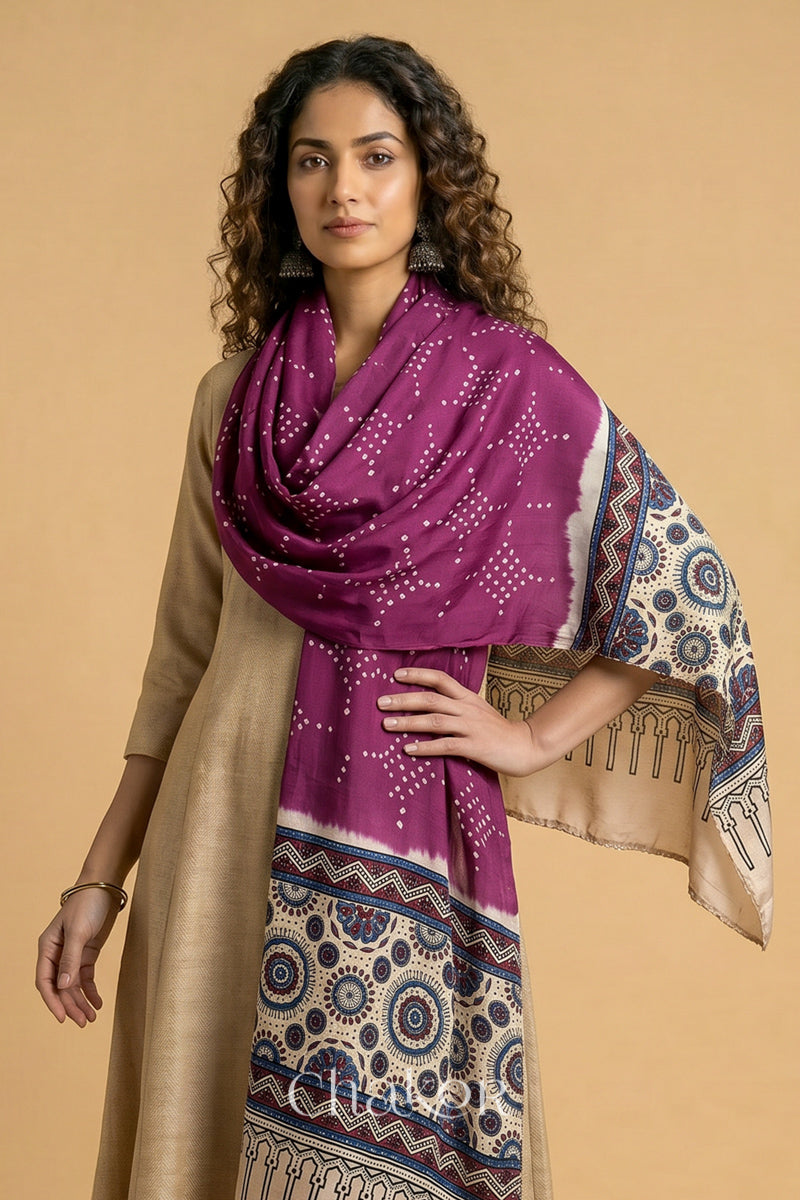  Magenta Bandhani modal stole styled across shoulders with detailed Off-white Ajrakh pallu and traditional hand tied pattern.
