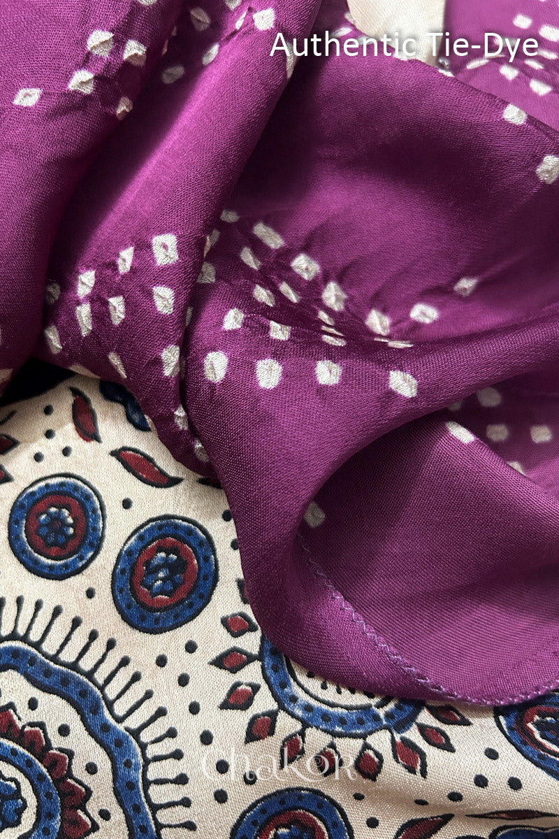 Magenta Hand tied Bandhani dots on modal stole with contrast ajrakh pallu detail showcasing fabric texture and softness.
